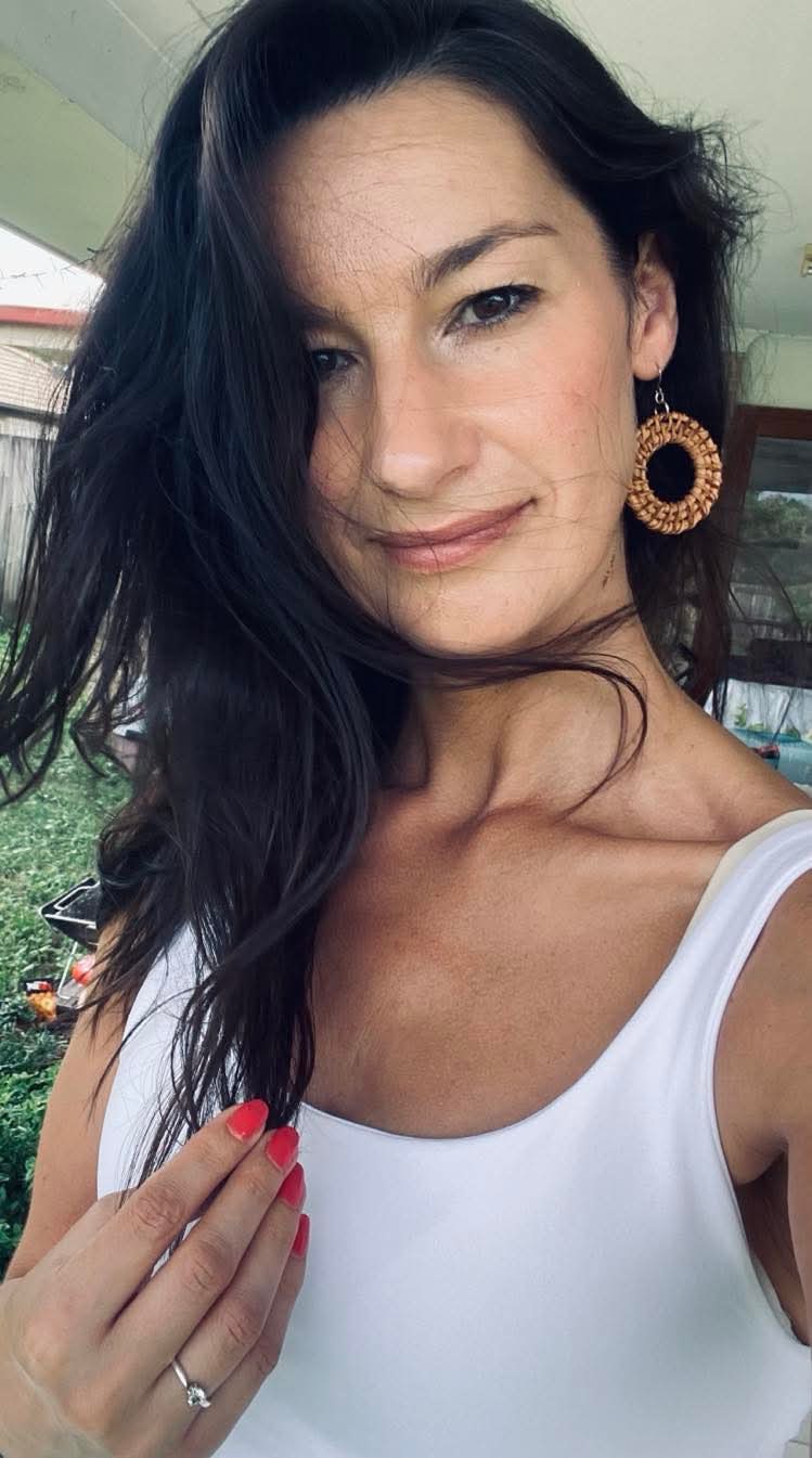 Anika, the founder of SoulShine, smiling warmly as a manifestation mentor dedicated to guiding deep personal transformation